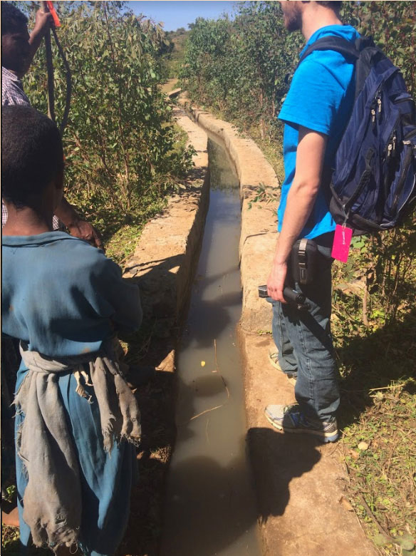 Ryan, above, stands next to the current canal system in the Abba Samuel River Watershed, Northwest Ethiopia in January 2016.