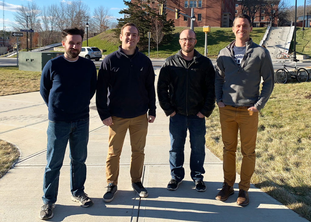 Competitors for the 2018 Graduate Student Speaking Competition stand by the Gant Science Complex. From left to right: Benjamin Bedard, Thomas Moran, Tyler Flanagan and Douglas Hendrix. (UConn photo/Stefan Schaffoener). 