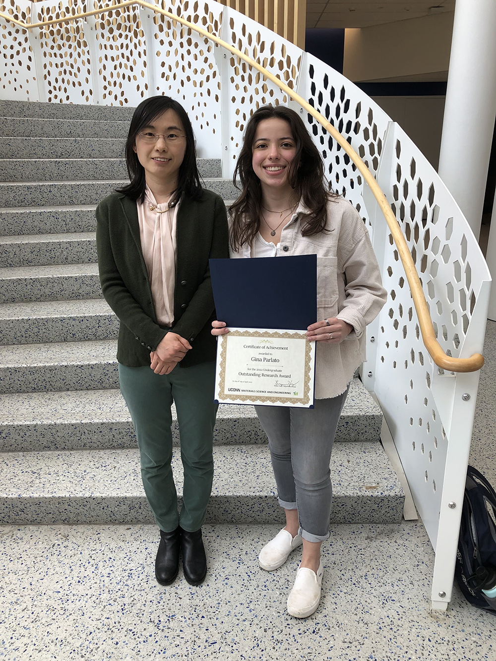 photo of Assistant Professor Xueju “Sophie” Wang standing with undergraduate Gina Parlato after the latter received the 2022 undergraduate outstanding research award.